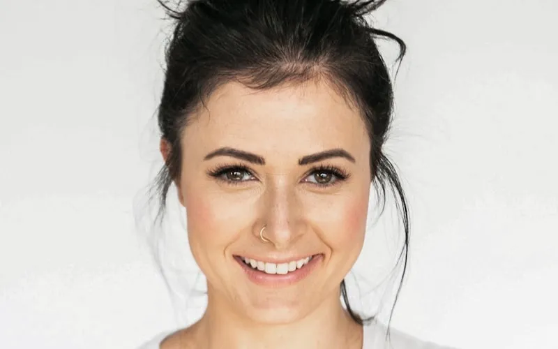 Patient smiling confidently with a complete set of restored teeth