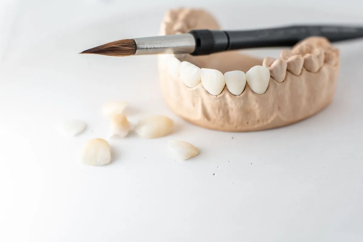 Dentist carefully fitting a custom dental crown for a patient